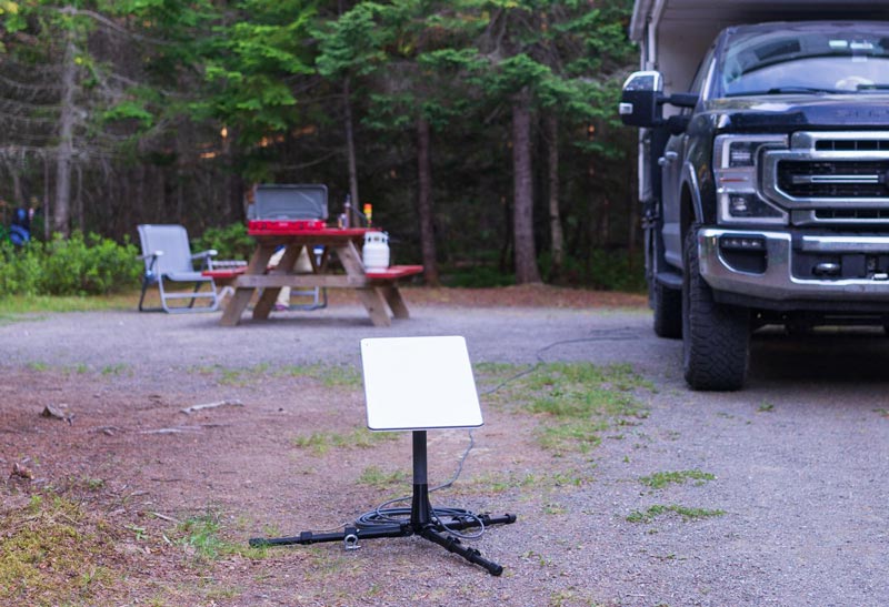 Campsite with starlink dish on ground